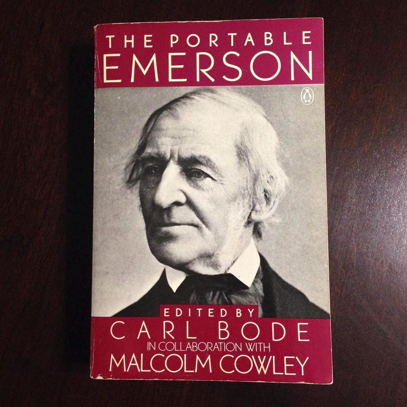May include: A red book with the title "The Portable Emerson" and the author "Edited by Carl Bode in collaboration with Malcolm Cowley". A black and white portrait of a man with white hair and a beard is on the cover.