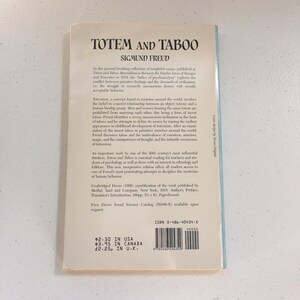 May include: A vintage paperback book cover with a white background and black text. The title is "Totem and Taboo" by Sigmund Freud. The book cover includes a description of the book and its contents, as well as pricing information.