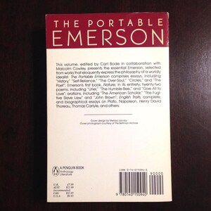 May include: The back cover of a Penguin paperback book titled "The Portable Emerson". The cover is white with black text and a barcode. The book is an anthology of literature by Ralph Waldo Emerson, edited by Carl Bode and Malcolm Cowley. The book includes essays, poems, orations, and biographical essays on Plato, Napoleon, Henry David Thoreau, and Thomas Carlyle.