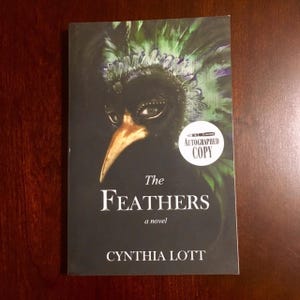SIGNED Cynthia Lott “The Feathers”. Paperback in very good condition.