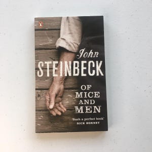 John Steinbeck “Of Mice And Men”. Paperback in good condition. Any wear is pictured.