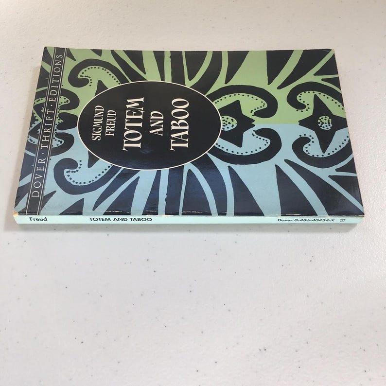 May include: A blue and black book with the title "Totem and Taboo" by Sigmund Freud. The book is part of the Dover Thrift Editions series.