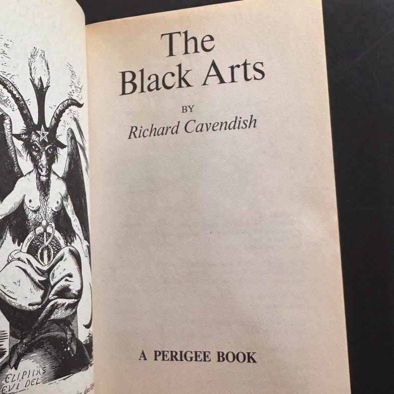 Może przedstawiać: Otwarta książka zatytułowana "The Black Arts" autorstwa Richarda Cavendisha. Ilustracja na lewej stronie przedstawia rogatą postać. Tekst "A Perigee Book" jest wydrukowany na dole strony.