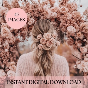 May include: A woman with long blonde hair wearing a pink sweater stands in front of a floral archway. The archway is made of pink and white flowers. The woman has a flower crown in her hair.