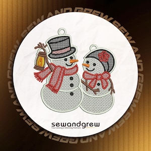 May include: Embroidered snowman couple with black top hats, red scarves, and carrot noses. One snowman holds a lantern. The design is on a white circle with the text "sewandgrew" and "Your sewing & Stitching Partners".