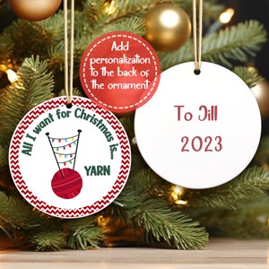 The image shows a knitting and crochet Christmas ornament.  The front of the Christmas ornament says All I want for Christmas is Yarn.  The back of the crochet ornament has a name and year.