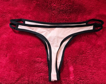 Pink cut-out thong with black contrast binding