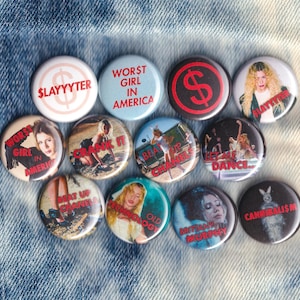 May include: A set of three ceramic mugs with a speckled, matte finish. The mugs are in shades of cream, light gray, and dark gray. Each mug has a simple, minimalist design and a rounded handle. The mugs are likely for coffee or tea.