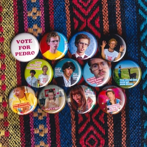 May include: A collection of 12 round button pins featuring images and text from the movie 'Superbad'. The buttons feature various characters and quotes from the film, including 'Vote for Pedro', 'All of your wildest dreams will come true', 'I've been chatting online with babes all day', 'Tina, you fat lard, come get some dinner', 'Make yourself a dang quesadilla', 'What's a liger?', and 'Surrounded by tiny little seahorses'.