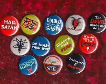 May include: A collection of 12 round button pins with various designs and slogans. The pins feature a variety of colors, including red, yellow, blue, green, and black. Some of the slogans include "Hail Satan", "Question Everything", "Diablo 666", "Do What Thou Wilt", "Reason Over Fear", "The Devil Made Me Do It", "Wouldst Thou Like To Live Deliciously", "Compassion & Empathy", "Church State", and "Thoughts & Prayers".