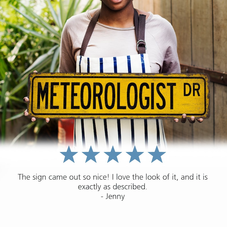 May include: A yellow sign with black text that reads "METEOROLOGIST DR". The sign is being held by a person wearing a striped apron.