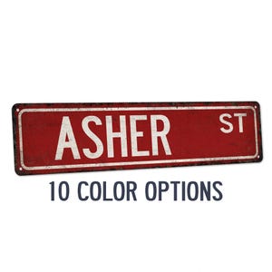 May include: Red metal street sign with white text that reads "ASHER ST".
