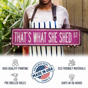 May include: A pink and white sign with the text "THAT'S WHAT SHE SHED ST" in black lettering. The sign is made in the USA and is eco-friendly.