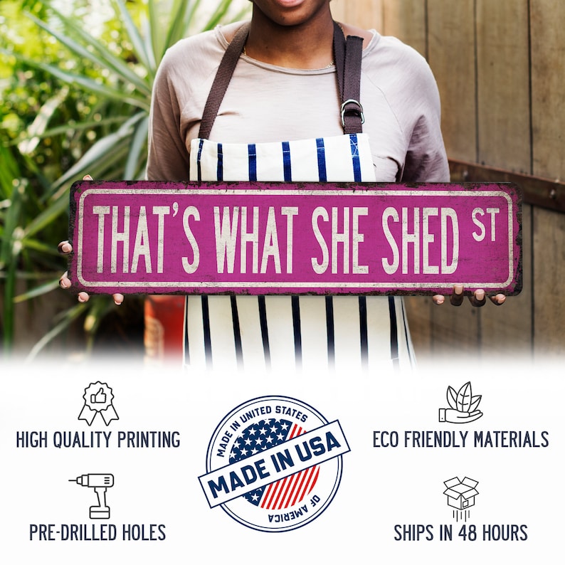May include: A pink and white sign with the text "THAT'S WHAT SHE SHED ST" in black lettering. The sign is made in the USA and is eco-friendly.
