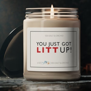 May include: A 9 oz candle with a white label that says "You just got lit up!" in red text. The candle is in a clear glass jar with a black lid. The candle is labeled "Sea Salt & Orchid".