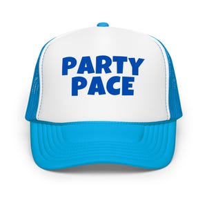 May include: A blue and white trucker hat with the words "PARTY PACE" in bold blue letters across the front. The hat has a blue brim and a white front panel, with blue mesh on the sides and back.