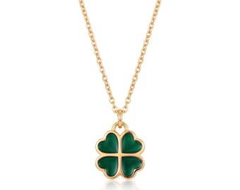 May include: A gold-toned necklace featuring a four-leaf clover pendant. The pendant is composed of four heart-shaped segments filled with a smooth, deep green enamel inlay, suspended from a delicate gold-toned chain link necklace.
