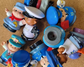 May include: A collection of Fisher-Price Little People plastic figures featuring various characters in uniform, including sailors, pilots, and train conductors. The figures are painted in blue, white, red, and black, with some showing the Little People logo.