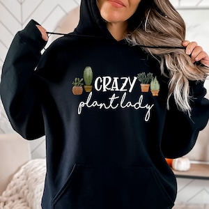 May include: Black hooded sweatshirt with the text "Crazy Plant Lady" and a graphic of potted cacti and succulents.