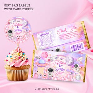 May include: A set of printable labels for a space-themed birthday party. The labels feature a pink and purple galaxy background with stars, planets, and a rocket ship. The text on the labels reads "Aeliana 1st Birthday Blast".