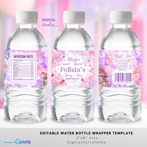 May include: Three clear water bottles with white caps and custom labels. The labels feature a floral design in pink and purple, with text that reads "Flutter and Twirl Felizia's Fairy First Birthday." The bottles are a water bottle wrapper template.