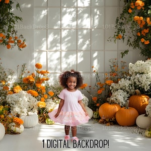 May include: A digital backdrop featuring a white wall with a window pane design, surrounded by orange and white flowers, pumpkins, and a young girl wearing a pink dress. The backdrop is perfect for fall-themed photoshoots.