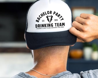 May include: Black and white trucker hat with the text "Bachelor Party Est. 2025 Drinking Team Frank's Last Fling Before The Ring" on the front.