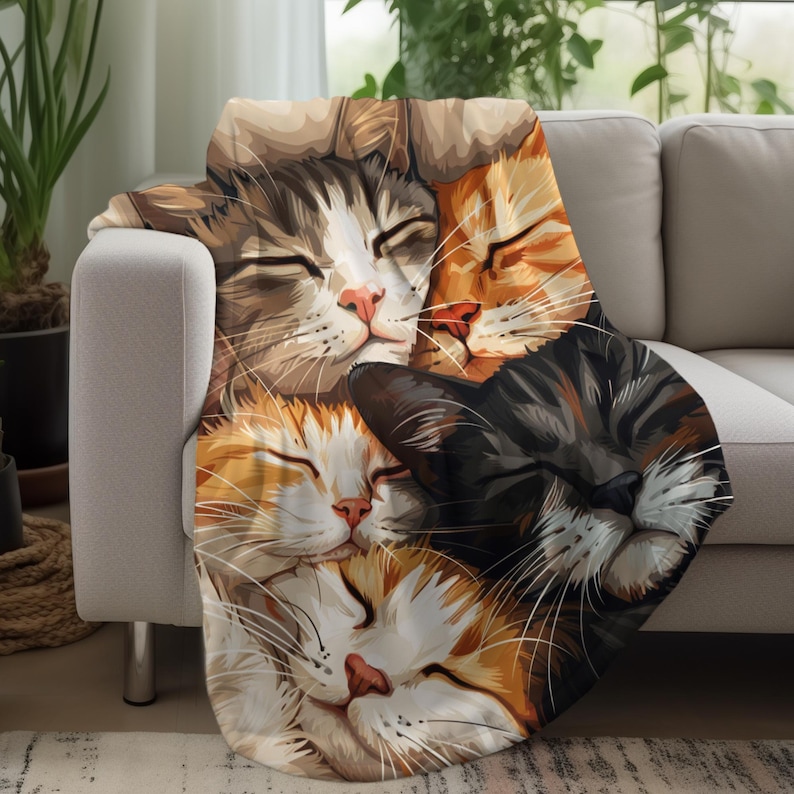 May include: A soft, cozy fleece blanket featuring a colorful illustration of four cats sleeping together. The cats are a tabby, a calico, a black and white cat, and a ginger cat. The blanket is perfect for cuddling up on the couch or in bed.