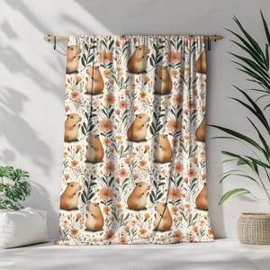 May include: A white curtain with a repeating pattern of brown guinea pigs and orange flowers. The guinea pigs are depicted in a cartoon style and are holding flowers.