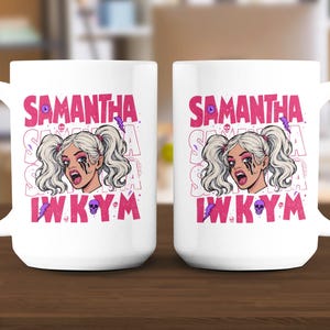 May include: White ceramic mug featuring a graphic of a woman with blonde pigtails and black eye makeup. The mug has the name "SAMANTHA" in pink, along with the letters "IWKYM" and other graphic elements. The mug is designed for beverages.