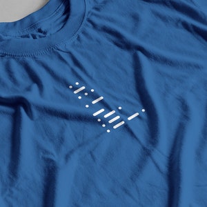May include: A blue t-shirt with a white geometric design on the front.