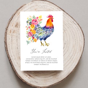 May include: A watercolor illustration of a rooster with a colorful floral bouquet behind it. The rooster is blue, purple, and orange. The flowers are pink, yellow, orange, and green. The text "You're Invited" is below the rooster.