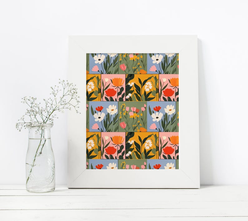 May include: A framed print featuring a colourful floral pattern. The print has a patchwork design of squares with different coloured backgrounds and floral illustrations. The flowers are in shades of pink, orange, yellow, and blue.