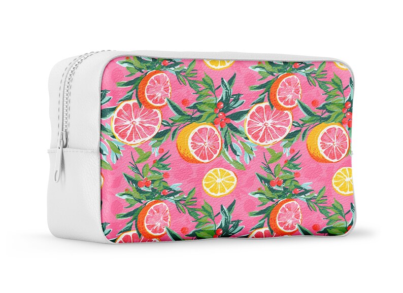 May include: White zippered pouch with a pink background and a repeating pattern of pink grapefruit slices, green leaves, and red berries.