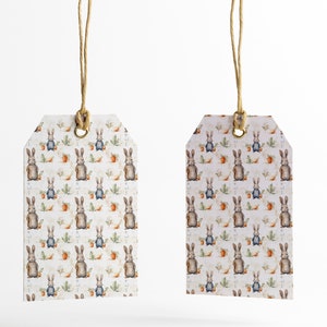 May include: Two white gift tags with a brown bunny rabbit pattern. The tags are tied with twine and have a brass eyelet.