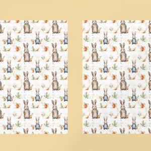 May include: A seamless pattern featuring watercolor illustrations of brown rabbits wearing blue overalls, green leaves, and orange carrots on a white background.