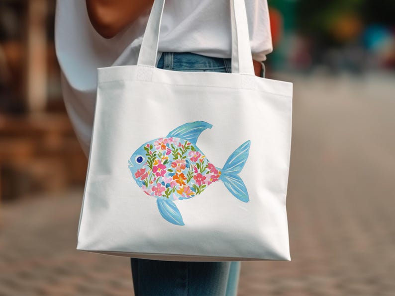 White tote bag with a colorful floral fish illustration.