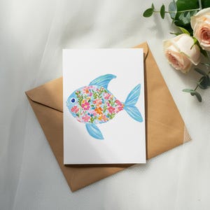 Greeting card with a colorful floral fish design on a brown envelope.
