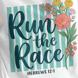 May include: White t-shirt with the text "Run the Race" in teal script, set against a teal and white striped background. Floral accents in pink, yellow, and orange adorn the right side. The text "HEBREWS 12:1" is at the bottom.