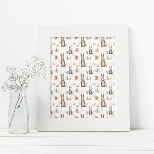 May include: A white framed print with a repeating pattern of brown rabbits holding carrots on a white background with green leaves and orange flowers.