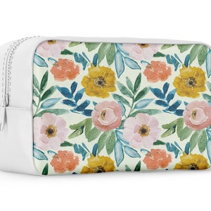 May include: White zippered pouch with a floral print featuring pink, yellow, and orange flowers on a light green background.