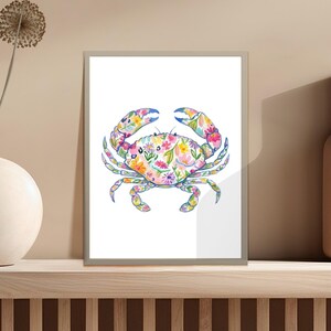 Crab illustration with colorful floral pattern on a white background in a frame.
