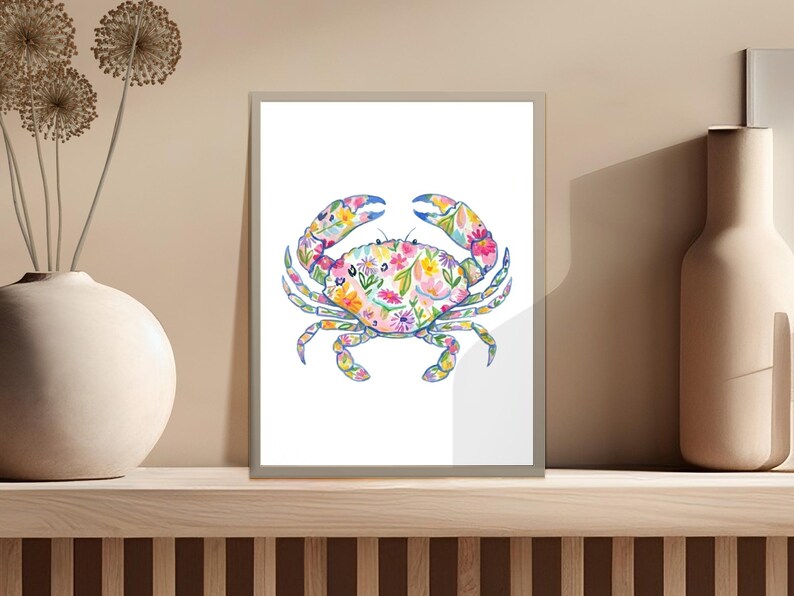 Crab illustration with colorful floral pattern on a white background in a frame.
