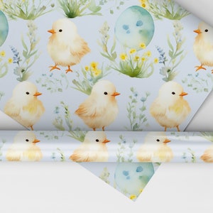 May include: A blue and white wrapping paper with a repeating pattern of yellow chicks, green leaves, and blue eggs. The paper is rolled up and the ends are visible.