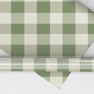 May include: A roll of green and white gingham wrapping paper. The paper is rolled up and the end is visible.