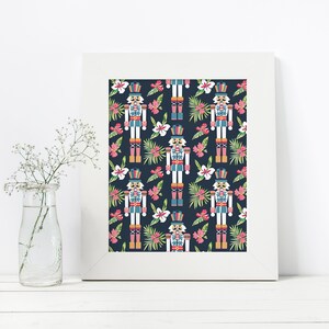 Pu&ograve; includere: Una stampa digitale con un motivo ripetitivo di soldati schiaccianoci e fiori tropicali su uno sfondo blu scuro. Gli schiaccianoci indossano costumi tradizionali con accenti rossi, blu e dorati. I fiori sono rosa, bianchi e verdi.