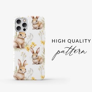 May include: A white phone case with a repeating pattern of brown bunnies and yellow flowers. The text "HIGH QUALITY pattern" is printed on the right side of the case.
