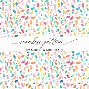 May include: A seamless pattern design with watercolour brushstrokes in blue, pink, orange, yellow, and green on a white background. The text "seamless pattern" and "BY MOORE & MOUNTAIN" are also visible.
