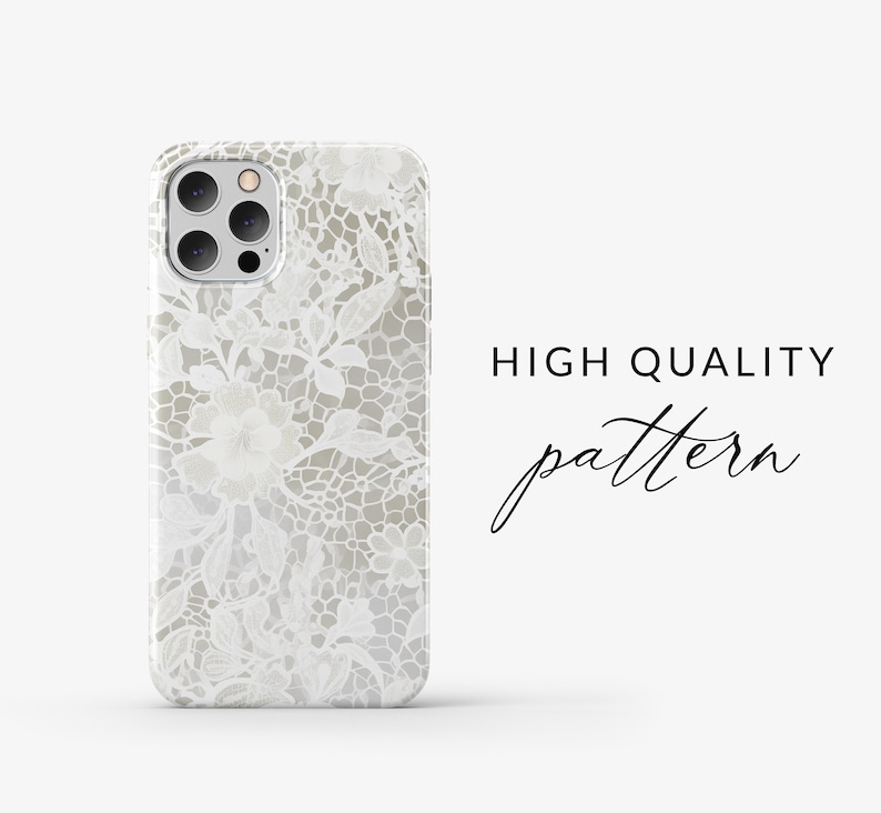 May include: A white phone case featuring a delicate lace pattern. The case has a cut-out for the camera lens.