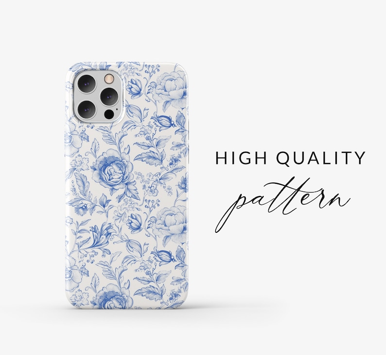 May include: A white iPhone case with a blue floral pattern. The case has a camera cutout and a raised lip around the edges. The text "HIGH QUALITY pattern" is visible in the background.